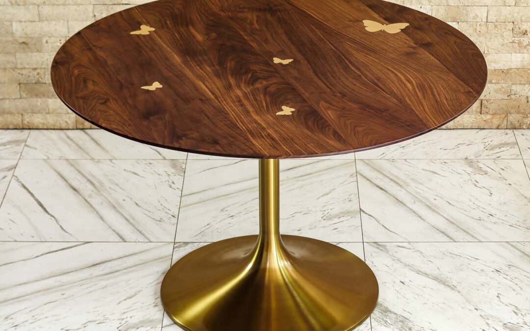 Round dining table in walnut wood with brass butterflies and tulip base – THB 120,000